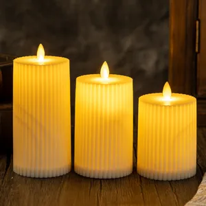 Atmospheric three-tiered fluted LED flameless candles with warm flickering yellow light