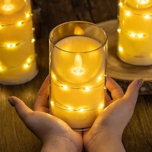 Realistic flameless LED candle with fairy lights in glass cylinder for cozy atmosphere.