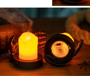 Close-up view of Halloween electronic candle with skull hand and battery compartment