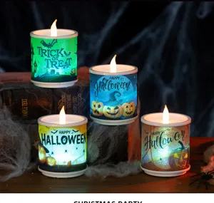 Four lit Halloween LED candles with pumpkin designs on vintage books with cobwebs