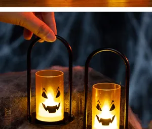 Close-up of a Halloween LED candle light featuring a ghost face design and a black handle