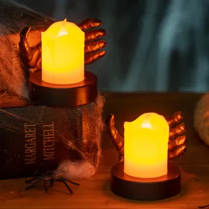 Spooky Halloween LED candle lamp held by black skeleton hand base for home party decor.