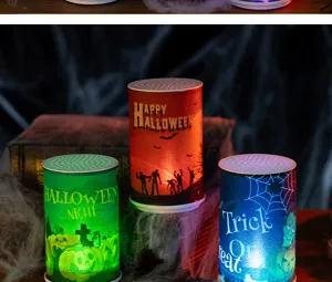 Detail showing three colorful Halloween LED candles with spooky ghost and pumpkin designs