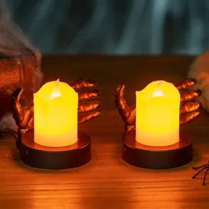 Spooky Halloween LED electronic candle held by a skeleton hand base for festive decor.