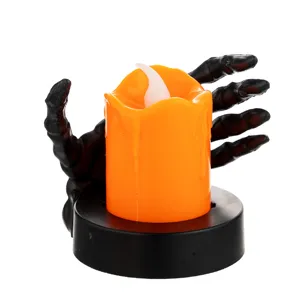 Halloween orange LED candle lamp held by a black skeleton hand on circular base