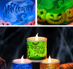 Close-up detail of glowing Halloween LED candles featuring Trick or Treat and pumpkin motifs