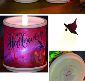 Close-up of Halloween LED candle featuring glowing pumpkin design and base switch details.