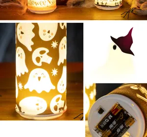 Detail view of Halloween ghost candle light showing battery compartment and motifs