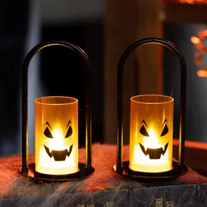 Halloween pumpkin LED candle lamps with black metal frames and warm atmospheric glow