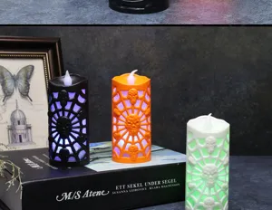 Detailed view of Halloween LED candles with skull and spider web designs in three colors