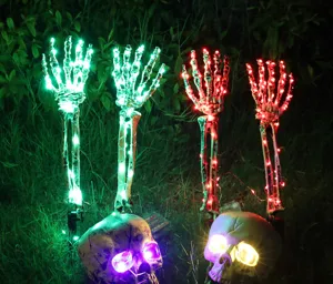 Detail view of glowing LED skeleton hands and skulls garden stakes for Halloween decor