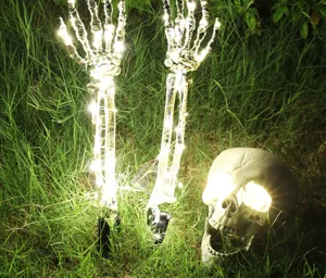 Glowing Halloween LED skeleton hands and skull lights for spooky outdoor garden garden decor.