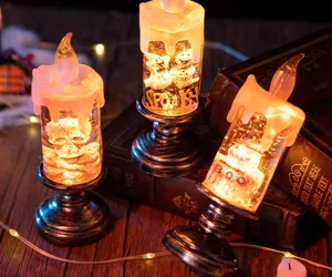 Warm glowing Halloween LED candles featuring spooky ghost and skull designs on books