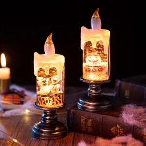 Atmospheric Halloween LED candle lights featuring ghost and pumpkin glitter tabletop decor