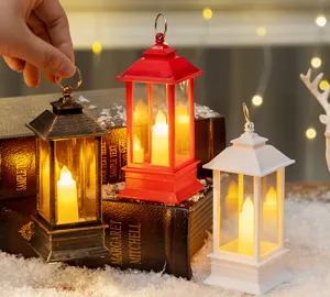 Close-up of three decorative LED lanterns in bronze, red, and white for Christmas