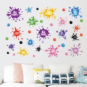Detailed view of colorful paint splatter wall stickers with inspirational quotes on white wall.
