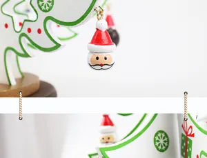 Macro detail of a miniature Santa Claus charm hanging on a wooden Christmas tree ornament.
