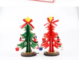 Pair of small wooden Christmas tree ornaments with colorful miniature hanging decorations