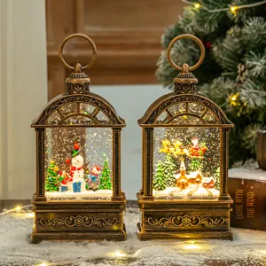 Lanternes de Noël vintage en bronze avec scènes de boule à neige lumineuses et Père Noël.