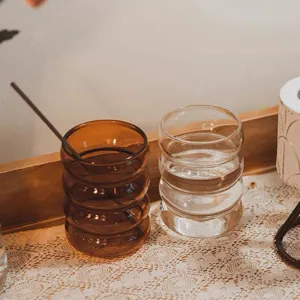 Ribbed glass cup detail, amber and clear caterpillar design water drinking cup.