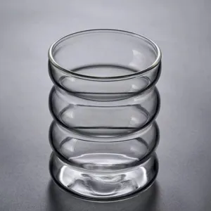 Detailed view of the grey ribbed glass cup, showcasing unique wave texture and quality.