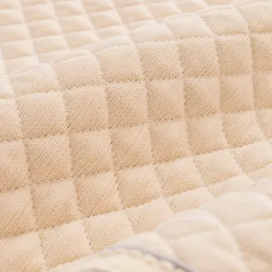 Beige quilted headboard cover fabric detail, elastic soft cushion anti-collision fabric.