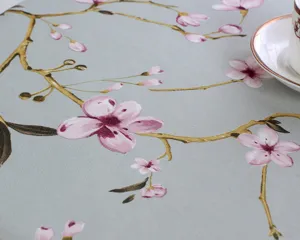 Detailed view of cotton linen tablecloth with elegant pink plum blossom floral print fabric.