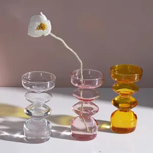 Detail shot of colorful glass bubble vases, stacking design, aesthetic home decor centerpiece.