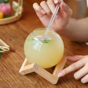Round glass globe cup with wooden stand and glass straw, perfect for drinks and iced coffee.