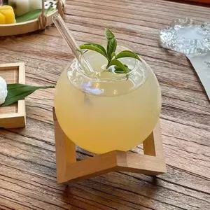 Creative spherical glass cup detail showcasing the unique moon shape design with wooden stand.
