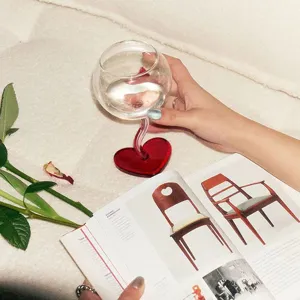 Heart-shaped wine glass with curved stem, unique romantic design for home parties and gifts.