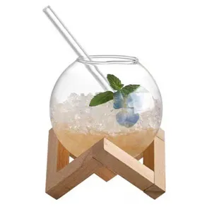 Clear round glass cup with wooden stand and straw, globe design for drinks, coffee, and cocktails.