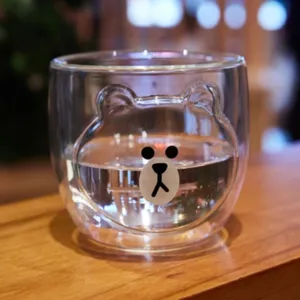 Creative double wall glass cup with cute cartoon bear design for home and office use.