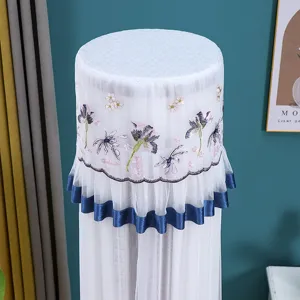 Detail shot of cylindrical vertical air conditioner dust cover with elegant lace embroidery and blue trim.