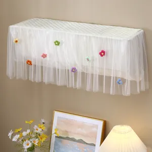 Detail view of a white wall-mounted air conditioner dust cover with floral mesh skirt.