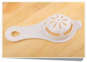Plastic egg separator detail view, practical kitchen tool for filtering egg whites easily.