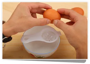 Detailed view of plastic egg white and yolk separator in use, kitchen gadget tool demonstration.