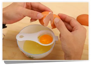 Plastic egg separator detail shot, effortless yolk and white separation for baking.