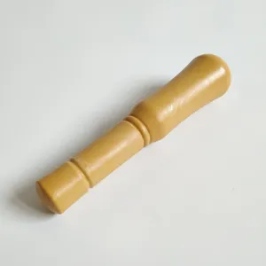 Close-up detail of a wooden garlic pestle tool, sturdy kitchen utensil for mashing herbs.