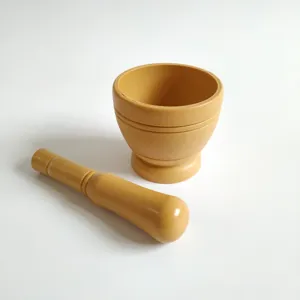 Manual garlic press mortar and pestle set detail view for kitchen food preparation use.