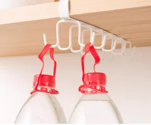 Close-up of a white under-cabinet hook rack holding heavy water bottles