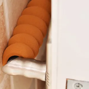 Orange spiral sponge door handle cover detail showing anti-collision protection and soft material.
