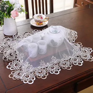 Exquisite lace dust cover for tea table and nightstand, elegant embroidered mesh fabric design.