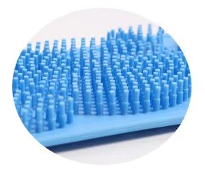 Detailed view of blue silicone back scrubber bristles texture, exfoliating bath tool closeup.