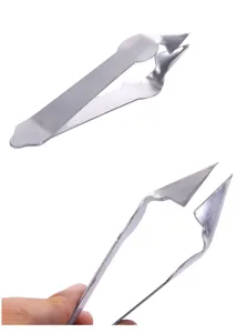Stainless steel pineapple eye remover tool detail view, sharp V-shaped tip for fruit.