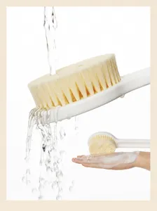 Long handle bath brush detail showing soft bristles and easy rinsing under running water.