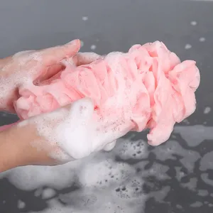 Pink mesh bath sponge for daily body cleaning, soft foaming loofah shower ball with rich soap suds.