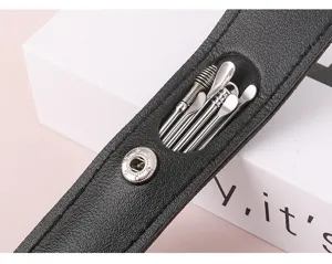 Close-up detail shot of 6-piece stainless steel ear pick set in black leather case.