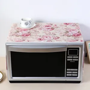 Floral microwave dust cover with delicate lace trim, vintage rose pattern top cloth.
