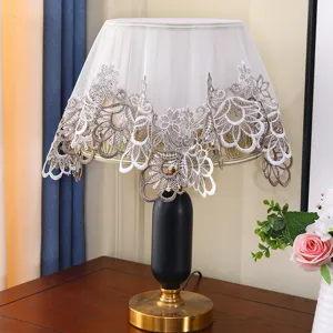 Exquisite lace table lamp cover with delicate embroidery details, elegant home decor accent.